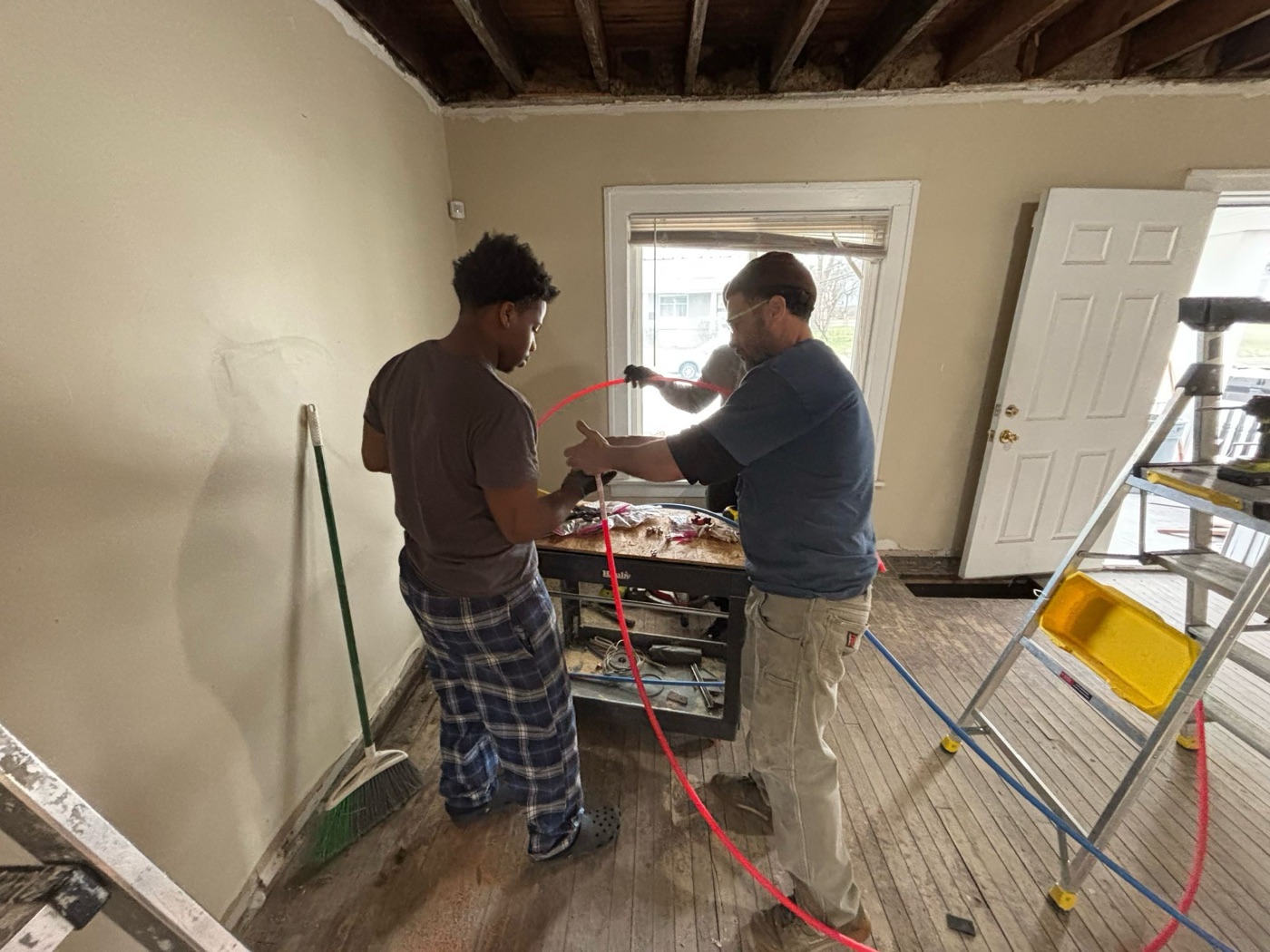 An experienced worker teaching a younger one on site